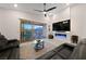 Living room featuring a ceiling fan, a modern fireplace and sliding doors that open to the outdoor patio and pool at 11900 Star Grass Ave, Las Vegas, NV 89138