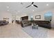 Open floorplan living area with kitchen, dining and Gathering room with neutral color scheme and natural light at 11900 Star Grass Ave, Las Vegas, NV 89138