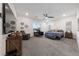 Spacious main bedroom featuring a ceiling fan, plush carpeting, and ample natural light at 11900 Star Grass Ave, Las Vegas, NV 89138