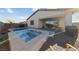 Backyard oasis featuring a pool, spa, and cozy seating area at 11900 Star Grass Ave, Las Vegas, NV 89138