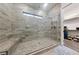 Modern bathroom featuring a walk-in shower with a built-in bench and neutral-toned tile at 11900 Star Grass Ave, Las Vegas, NV 89138