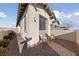 Cozy side patio with comfortable seating, a small table, and manicured landscaping at 11900 Star Grass Ave, Las Vegas, NV 89138