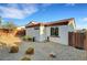 Backyard view with desert landscaping, rock features, and fencing at 1544 Tilman Ln, Boulder City, NV 89005