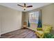 This cozy bedroom features a ceiling fan, natural lighting, and wood-look flooring at 1544 Tilman Ln, Boulder City, NV 89005