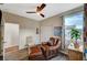 This home bedroom offers a ceiling fan and comfortable sitting area bathed in natural light at 1544 Tilman Ln, Boulder City, NV 89005