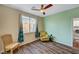 Bedroom features wood-look floors, a ceiling fan, and natural lighting at 1544 Tilman Ln, Boulder City, NV 89005