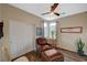 Comfortable bedroom features a ceiling fan, chair with ottoman, and plenty of natural light at 1544 Tilman Ln, Boulder City, NV 89005