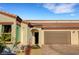 Charming home exterior showcases tile roof, manicured yard and a two-car garage at 1544 Tilman Ln, Boulder City, NV 89005