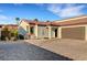 Charming home featuring a tile roof and a paved driveway, with a brown garage door at 1544 Tilman Ln, Boulder City, NV 89005