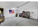 Spacious garage featuring a speckled floor, storage shelves, and an American flag at 1544 Tilman Ln, Boulder City, NV 89005