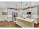 Modern kitchen with white cabinets, quartz countertops, and stainless steel appliances at 1544 Tilman Ln, Boulder City, NV 89005