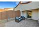 Back patio with brick pavers and outdoor seating, adjacent to sliding glass doors at 1544 Tilman Ln, Boulder City, NV 89005