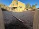 View of a desert landscaped backyard with the yellow home exterior in the background at 161 Lenape Heights Ave, Las Vegas, NV 89148