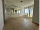 Main bathroom with a double vanity, large mirror, tiled floors, and shower at 161 Lenape Heights Ave, Las Vegas, NV 89148