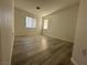 Bedroom featuring modern wood-look flooring, windows, and neutral walls, a cozy and inviting space at 161 Lenape Heights Ave, Las Vegas, NV 89148