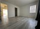 Bright bedroom with modern wood-look floors, window, and neutral walls, creating a warm atmosphere at 161 Lenape Heights Ave, Las Vegas, NV 89148