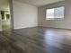 View of a bedroom with wood laminate floors, and a window overlooking the neighborhood at 161 Lenape Heights Ave, Las Vegas, NV 89148