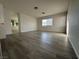 Spacious bedroom with wood laminate floors, white walls, and a view of the bathroom at 161 Lenape Heights Ave, Las Vegas, NV 89148