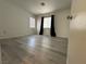 Bedroom featuring wood-look flooring, two windows and neutral walls, a blank canvas for customization at 161 Lenape Heights Ave, Las Vegas, NV 89148