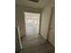 Hallway features wood-look floors, and a view into a bright room creating a warm and inviting atmosphere at 161 Lenape Heights Ave, Las Vegas, NV 89148