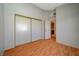 Bedroom with wood-look floors and mirrored closet doors at 1800 Edmond St # 252, Las Vegas, NV 89146