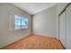 Well-lit bedroom with wood-look floors and a large window at 1800 Edmond St # 252, Las Vegas, NV 89146