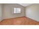 Spacious bedroom featuring wood-look flooring and window at 1800 Edmond St # 252, Las Vegas, NV 89146