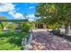 Landscaped yard with brick patio and a bench near the house at 1808 Birch St, Las Vegas, NV 89102