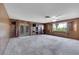 Spacious living room with wood paneling and large windows at 1808 Birch St, Las Vegas, NV 89102