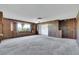 Spacious living room with wood paneling and large window at 1808 Birch St, Las Vegas, NV 89102