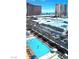 Aerial view of the pool with lounge chairs and surrounding cityscape at 2000 N Fashion Show Dr # 2305, Las Vegas, NV 89109