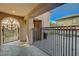 Covered back porch with decorative metal railing and a view of the fire pit and outdoor seating area at 2124 Pont National Dr, Henderson, NV 89044