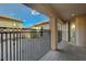 Covered back porch with decorative metal railing and a view of the fire pit and outdoor seating area at 2124 Pont National Dr, Henderson, NV 89044