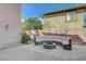 Backyard featuring a built-in stone bench around a fire pit and stamped concrete flooring at 2124 Pont National Dr, Henderson, NV 89044