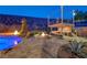 Beautiful backyard with a pool, outdoor kitchen, elevated deck and a built-in fire pit at 2124 Pont National Dr, Henderson, NV 89044