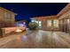 Spacious backyard patio with a built in fire pit, seating and outdoor access at 2124 Pont National Dr, Henderson, NV 89044