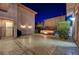 Spacious backyard patio with a built in fire pit, seating and outdoor lights at 2124 Pont National Dr, Henderson, NV 89044