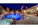 Backyard pool with a stone waterfall, jacuzzi and a covered outdoor living space and BBQ at 2124 Pont National Dr, Henderson, NV 89044