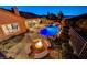 Backyard featuring a pool with a waterfall, a stone fire pit and comfortable seating surrounding it at 2124 Pont National Dr, Henderson, NV 89044