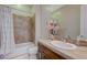 Bathroom featuring a tiled shower-tub, single vanity, and plenty of counter space at 2124 Pont National Dr, Henderson, NV 89044