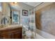 Cozy bathroom featuring a single sink, tile backsplash, and a shower-tub combo at 2124 Pont National Dr, Henderson, NV 89044