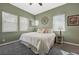 Comfortable bedroom features gray carpet, three windows, and light green walls at 2124 Pont National Dr, Henderson, NV 89044