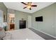 Bedroom with a ceiling fan, neutral walls, and doorway access to an adjacent bathroom at 2124 Pont National Dr, Henderson, NV 89044