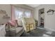 Charming bedroom featuring a cozy armchair, a play tent, and decorative shelves for a playful ambiance at 2124 Pont National Dr, Henderson, NV 89044