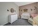 Bedroom with a pink accent wall, crib, chair, dresser, and rose-themed accents at 2124 Pont National Dr, Henderson, NV 89044