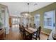 Bright dining room with hardwood floors, natural light, and a decorative chandelier at 2124 Pont National Dr, Henderson, NV 89044