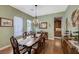 Dining room with hardwood floors, natural light, and a decorative chandelier at 2124 Pont National Dr, Henderson, NV 89044