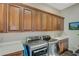 Laundry room features built-in cabinets, sink, and modern washer and dryer at 2124 Pont National Dr, Henderson, NV 89044