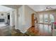 Transitional living area with tile and hardwood floors, columns, and backyard access at 2124 Pont National Dr, Henderson, NV 89044