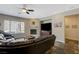 A living room with a fireplace, large window, and a dark wood entertainment center at 2124 Pont National Dr, Henderson, NV 89044